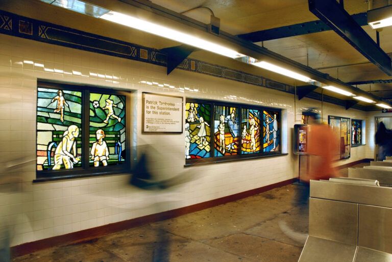 These faceted glass panels by Josie Gonzalez explore the movement of bodies through space, with figures of children sliding, swinging, running, and tossing balls.