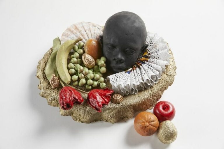 The head of a young Black child surrounded by a lace collar, tulips and fruits.