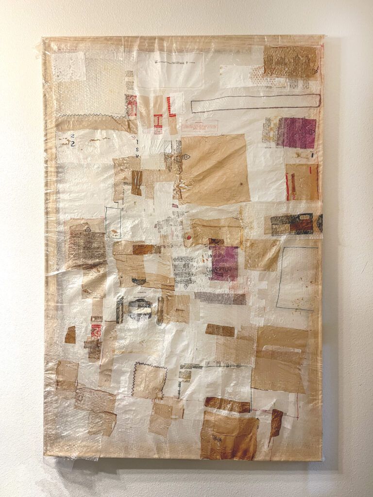 A collage of materials mounted on a canvas. Materials include recycled plastic and beads quilted together.