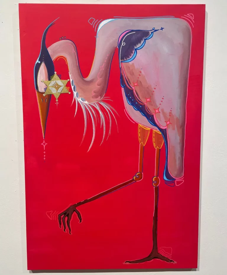 A Great Blue Heron standing with one leg up. The bird has a sheriff badge over its face.